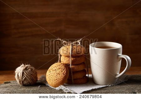 Traditional Christmas Tea Concept With A Cup Of Hot Tea, A Large Set Of Cookies On A Homespun Napkin