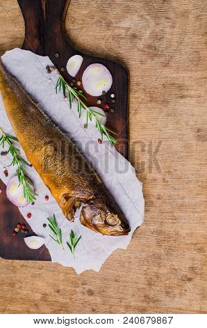Smoked Whole Fish With Spices On Wooden Background. Selective Focus.