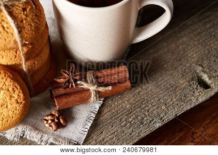 Traditional Christmas Tea Concept With A Cup Of Hot Tea, A Large Set Of Cookies On A Homespun Napkin
