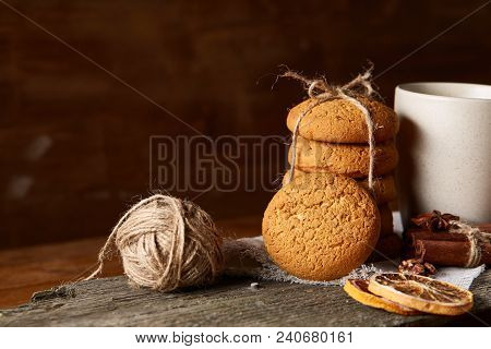 Traditional Christmas Tea Concept With A Cup Of Hot Tea, A Large Set Of Cookies On A Homespun Napkin