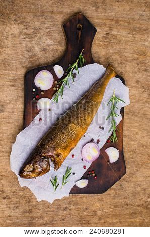 Smoked Whole Fish With Spices On Wooden Background. Selective Focus.