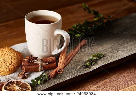 Traditional Christmas Tea Concept With A Cup Of Hot Tea, A Large Set Of Cookies On A Homespun Napkin
