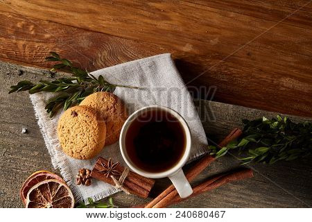Traditional Christmas Tea Concept With A Cup Of Hot Tea, A Large Set Of Cookies On A Homespun Napkin