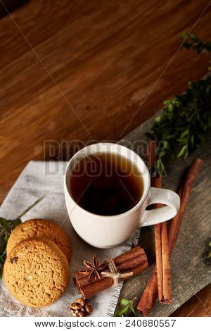 Traditional Christmas Tea Concept With A Cup Of Hot Tea, A Large Set Of Cookies On A Homespun Napkin