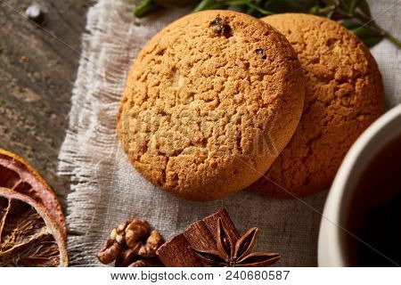 Traditional Christmas Tea Concept With A Large Set Of Cookies On A Homespun Napkin, Cinnamon Sticks 