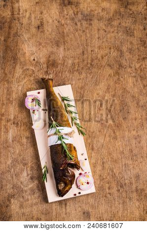 Smoked Whole Fish With Spices On Wooden Background. Selective Focus.