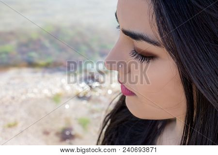 Happy Woman On The Beach. Portrait Of A Beautiful Girl Close-up. Spring Portrait On The Beach. Young
