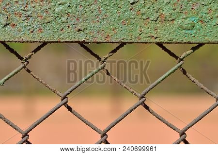 A Fence Made Of Iron Net.the Wire Is Twisted Into A Rigid Mesh .