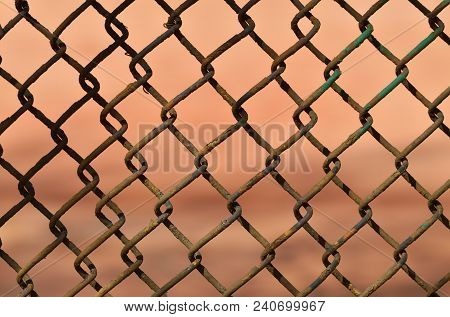 A Fence Made Of Iron Net.the Wire Is Twisted Into A Rigid Mesh .
