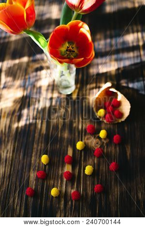 Blossoming Red Tulips On A Wooden Background With Sweets