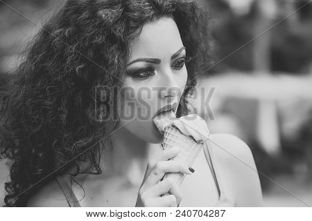 Sexy Young Brunette Lady With Curly Hair And Bright Makeup Licking Cold Dessert Of Red Berry Ice Cre