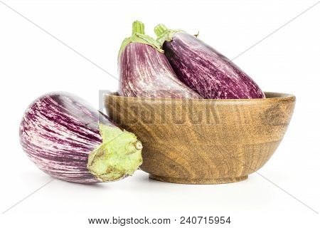 Three Striped Purple Eggplants In A Wooden Bowl Isolated On White Background