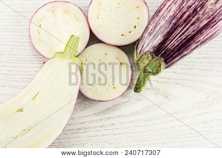 Striped Purple Eggplants Set Top View Isolated On Grey Wood Background Whole One Half And Sliced Thr
