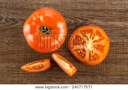 Red Tomato Collection Top View Isolated On Brown Wood Background One Whole One Section Half And Two 