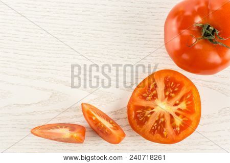 Red Tomato Collection Isolated On Grey Wood Background Top View One Whole One Section Half And Two S