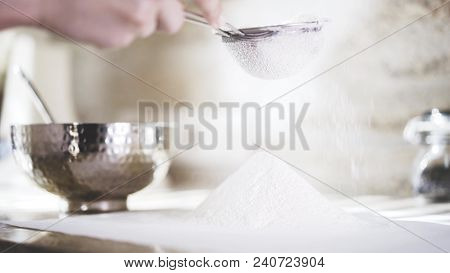 A Closeup Of A Woman Sifting A Flour Through A Little Sieve. A Woman Holding A Little Sieve To Sift 