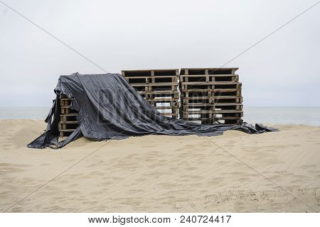 Stack Of Palette On The Beach Covered With Plastic