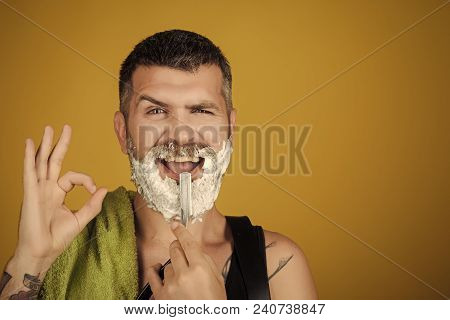 Happy Hipster In Barbershop, New Technology. Man Cut Beard And Mustache With Razor And Shaving Gel. 