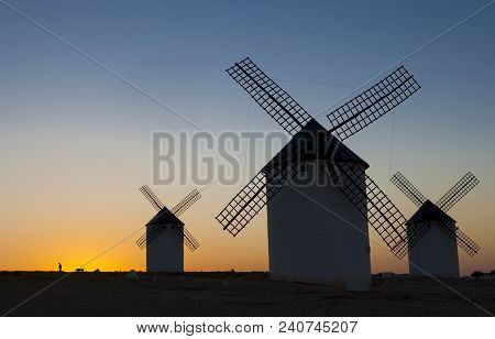 Man Walking The Dog At Rising Through The Campo De Criptana Windmills Site, Spain