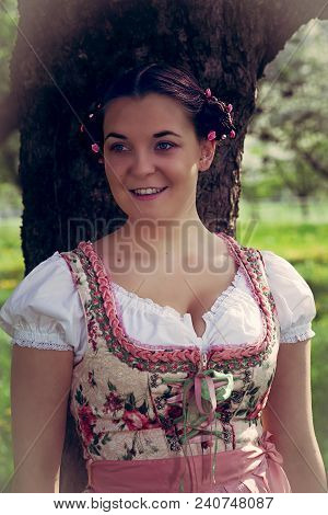 Portrait Of A Young Bavarian Girl In Dirndl And Braid Hairstyle