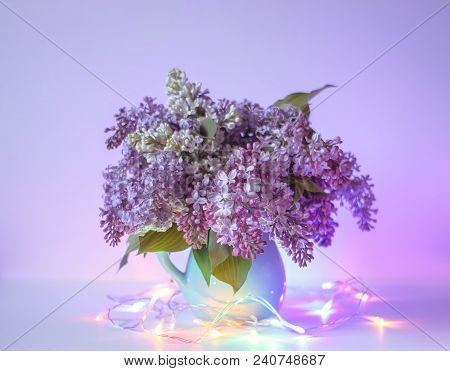 Beautiful Bouquet Of Fragrant Purple Flowers In Blue Ceramics Vase On Light Background With Festive 
