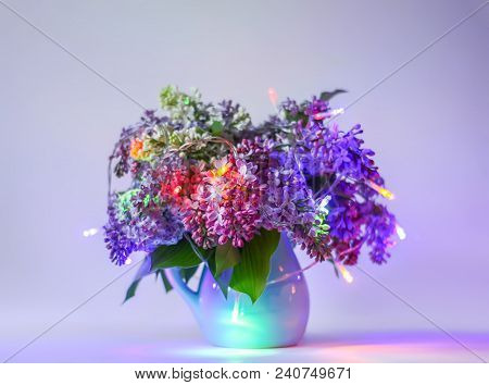 Beautiful Bouquet Of Fragrant Purple Flowers In Blue Ceramics Vase On Light Background With Festive 