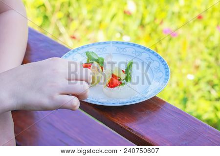 Ice Cube With Strawberry, Lemon And Fresh Green Mint Leaves In White Plate Outdoors