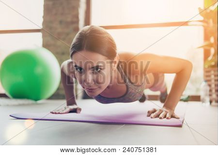 Low-angle Close Up Portrait Of Beautiful Confident Will-powered Successful Sportswoman Doing Push-up
