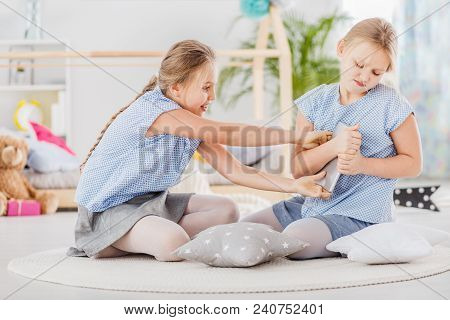 Girl Grabbing Tablet From Sister
