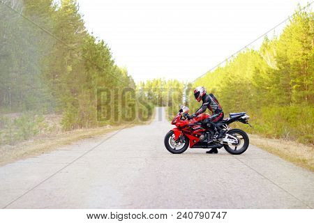 Krasnoyarsk, Russia - April 27, 2018: Beautiful Motorcyclist In Full Gear And Helmet On A Red And Bl