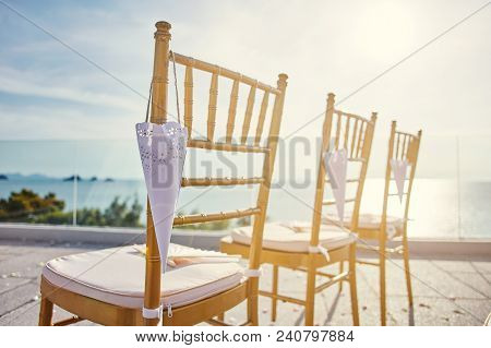 Beach Wedding Venue Setup With Modern Style Of Gold Chiavari Chairs With Cone Of Rose Petal Hanging 