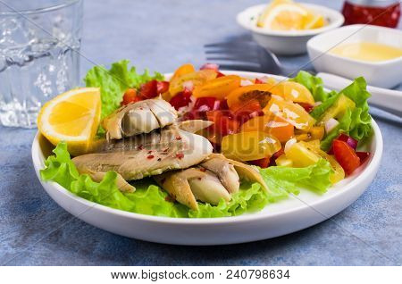 Fish Fillet With Raw Vegetables And Lemon In A Dish On The Table. Selective Focus.