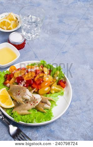 Fish Fillet With Raw Vegetables And Lemon In A Dish On The Table. Selective Focus.