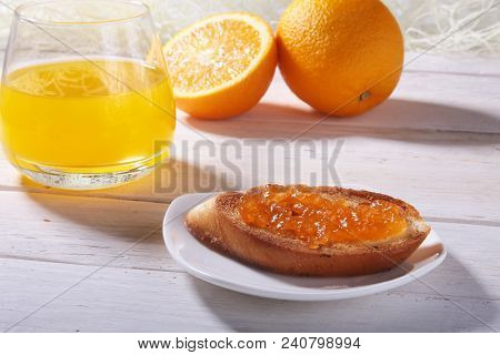 Morning Breakfast Set With Orange Jam On Bread Toast And Juice In Glass