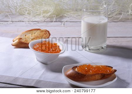 Morning Breakfast Set With Orange Jam On Bread Toast And Milk In Glass