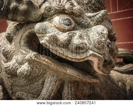 Traditional Chinese Stone Lion Sculpture In Front Of A Buddhist Temple