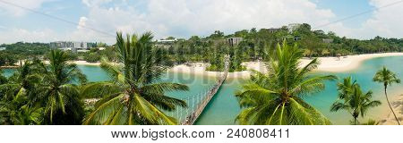 Paradise Beach Panorama With Blue Water And Palm Trees