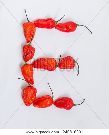 Letter E Alphabet Made With Ghost Pepper Bhoot Jolokia Over White Background
