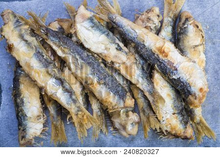 Fried Sardines On A Slate Background