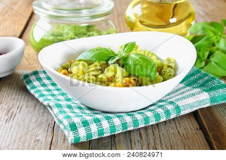 Pasta With Pesto Sauce On An Old Wooden Table
