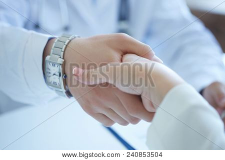 Male Doctor Shaking Hands With Patient. Partnership, Trust And Medical Ethics Concept. Thankful Hand