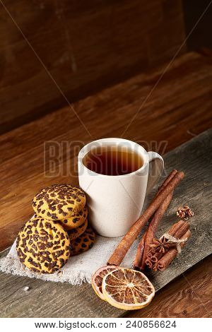 Traditional Christmas Tea Concept With A Cup Of Hot Tea, A Large Set Of Cookies On A Homespun Napkin
