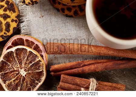 Traditional Christmas Tea Concept With A Cup Of Hot Tea, A Large Set Of Cookies On A Homespun Napkin