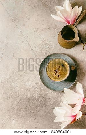 Blue Cup Of Black Espresso Coffee, Vintage Jezva And Spring Flowers Magnolia Branches Over Grey Text