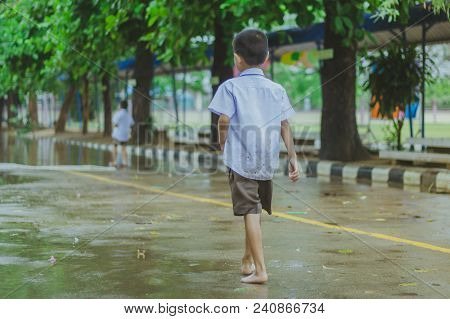 Students Walk To The Flood After Rain In School.