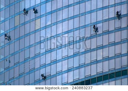 Moscow, Russia - May, 13, 2018: Steeplejacks work on a wall of Moscow city building