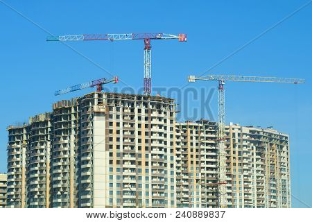 Saint Petersburg, Russia - April 12, 2018: Construction Cranes Over Multystoried Houses Under Constr