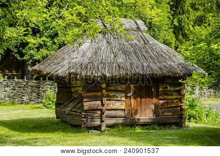 A Small Ancient Wooden Structure With Thatched Roof