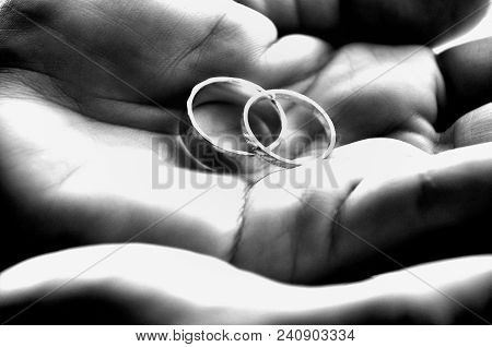 Paired: Set Of Rings In Hands In Black & White
