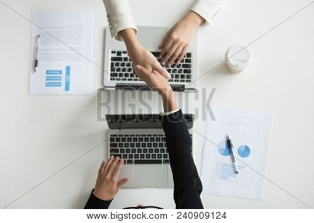 Top View Of Partners Or Ceos Handshaking, Making Agreement On Cooperation Or Companies Merging Durin